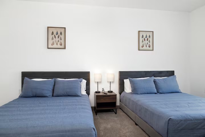 Bedroom — two beds with blue bedding