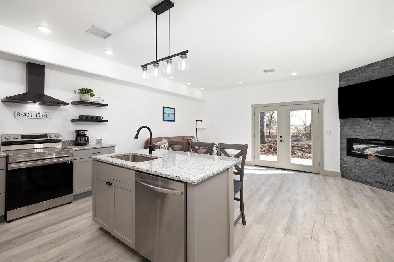 Kitchen island with fireplace beyond