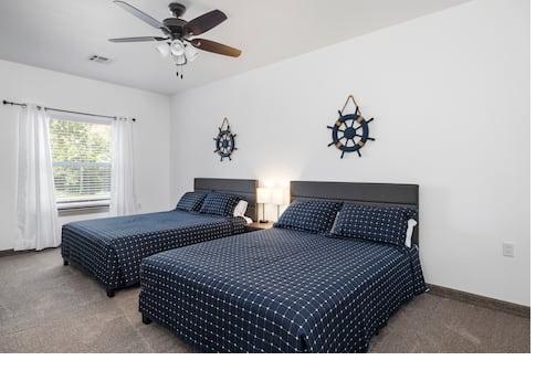 Nautical bedroom — wide shot with two queen beds