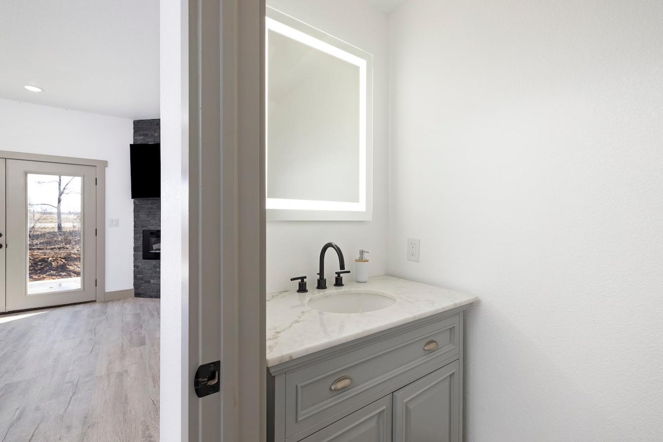 Half bath — sink with fireplace view