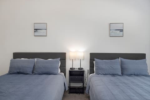 Twin beds with framed photos & lantern nightstand