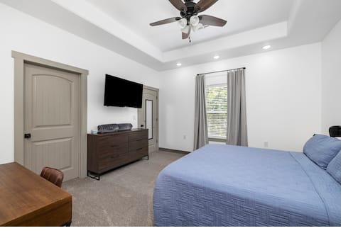 Master bedroom — wide view with TV & dresser