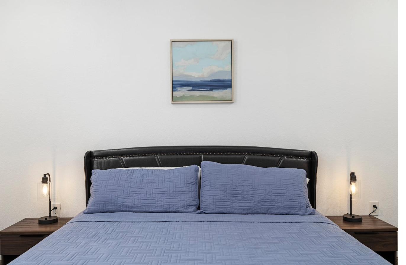 Master bedroom — abstract landscape painting above headboard